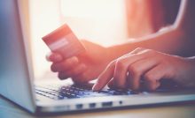 Online shopping with credit card and laptop